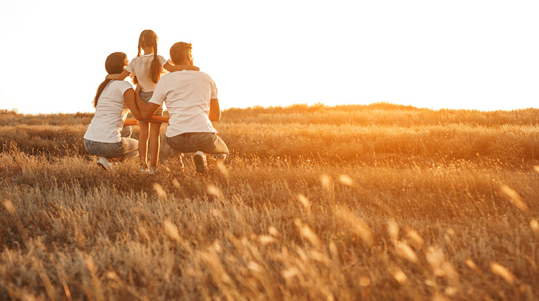 happy family on a farm at sunset