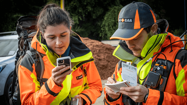 Land Search and Rescue volunteers looking at a map