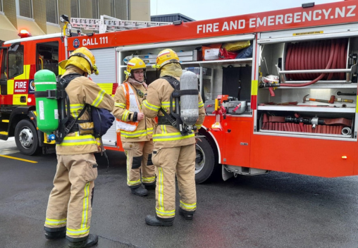 Fire and Emergency New Zealand volunteers in front of fire truck.