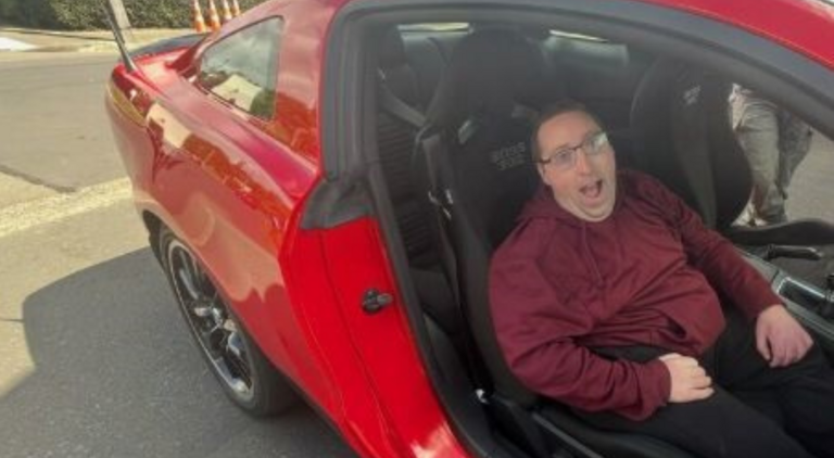 Man sitting in red mustang