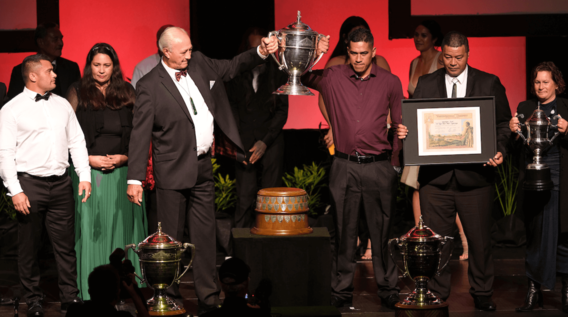 Ahuwhenua Trophy 2021 winners holding up trophy