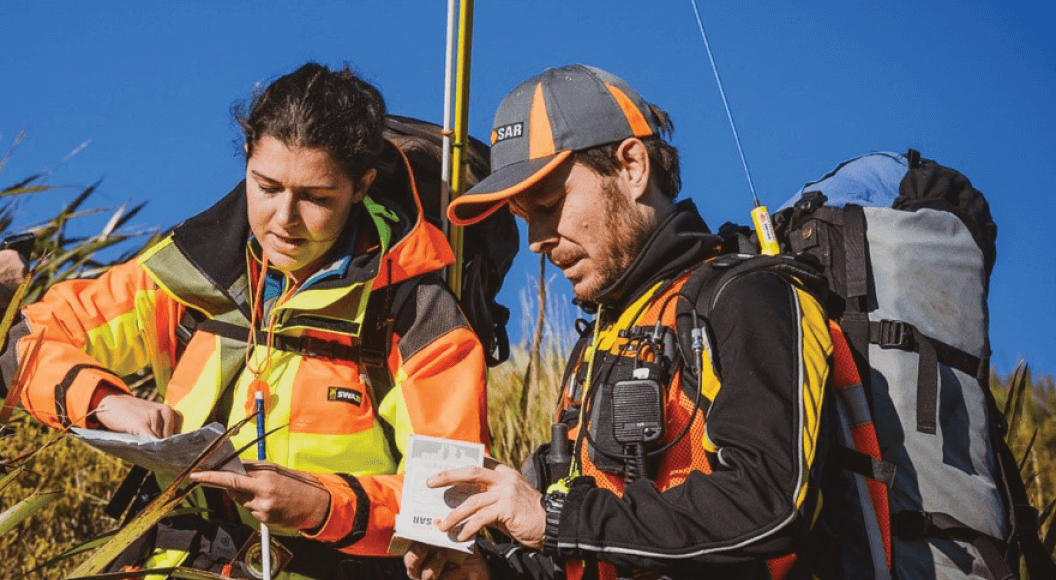 Land Search and Rescue volunteers looking at a map