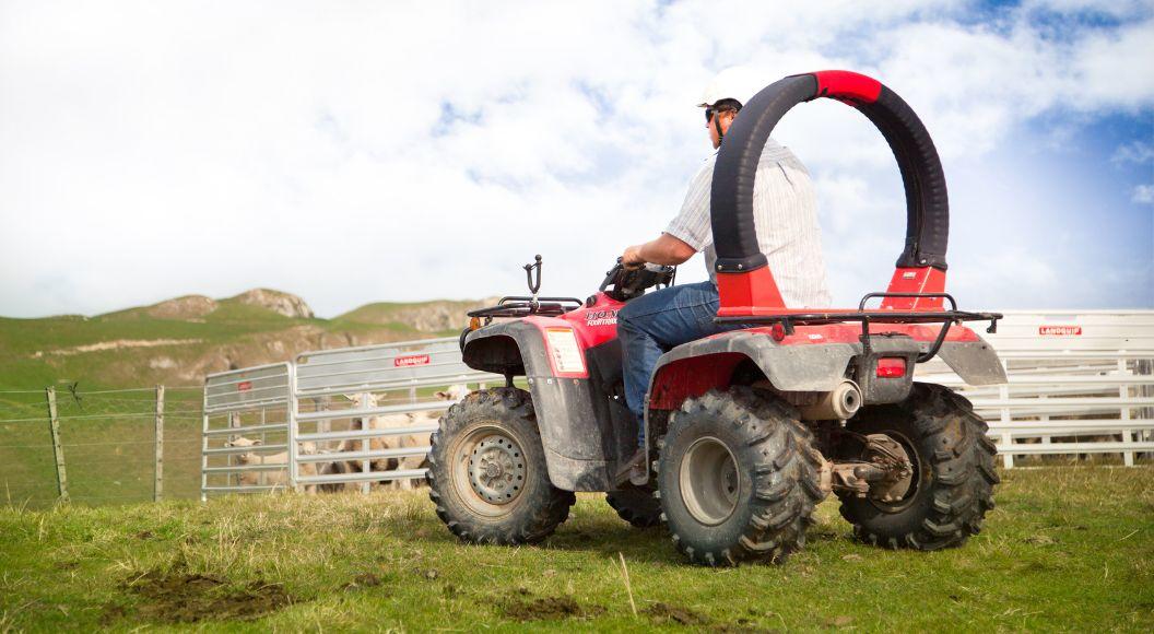 Farmer on quad bike with Trax Equipment crush protection device installed.
