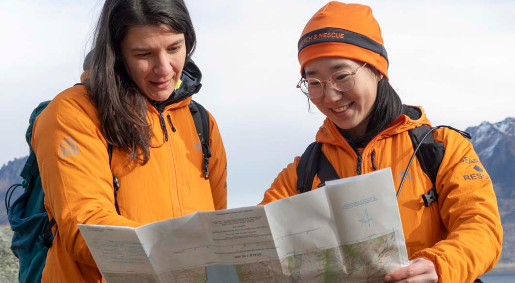 Land Search and Rescue volunteers look at map